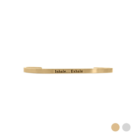 Gold cuff bracelet with 'Inhale... Exhale' text on a white background