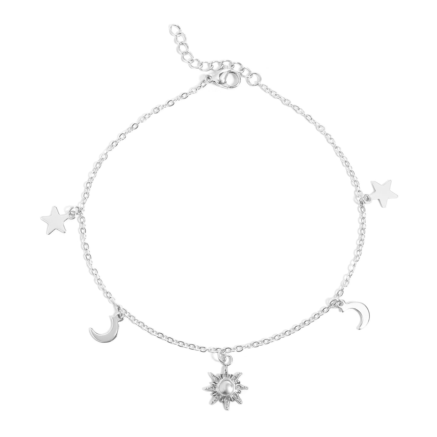 Silver anklet with star, moon, and sun charms on a white background