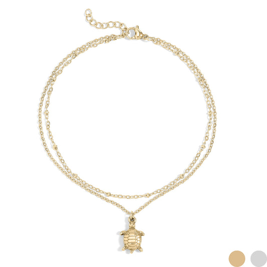 Gold layered anklet with sea turtle charm on a white background