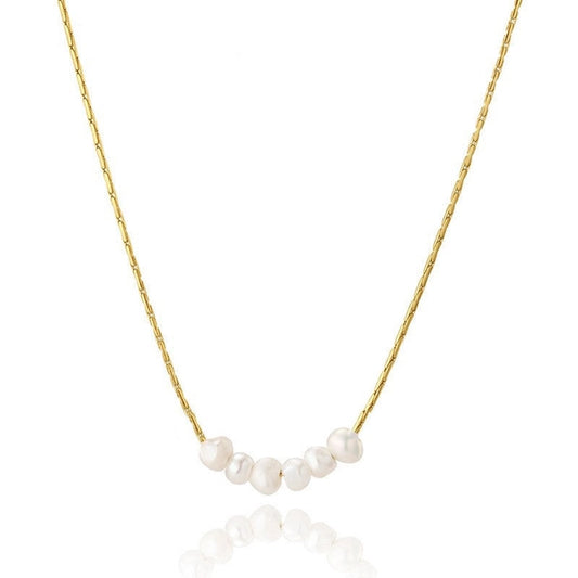 Gold necklace with white pearls on a white background