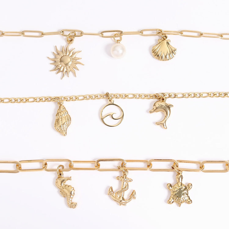 Three horizontal gold necklaces with 9 various charms, 3 on each necklace