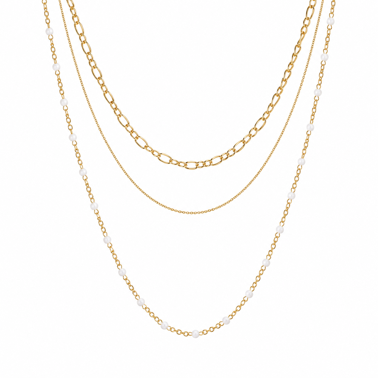 Three layered gold-tone necklaces displayed against a solid white background. The necklaces include a beaded chain with small white beads, a figaro chain, and a delicate cable chain.