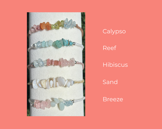 Set of colorful bracelets on a white card with color names on a pink background