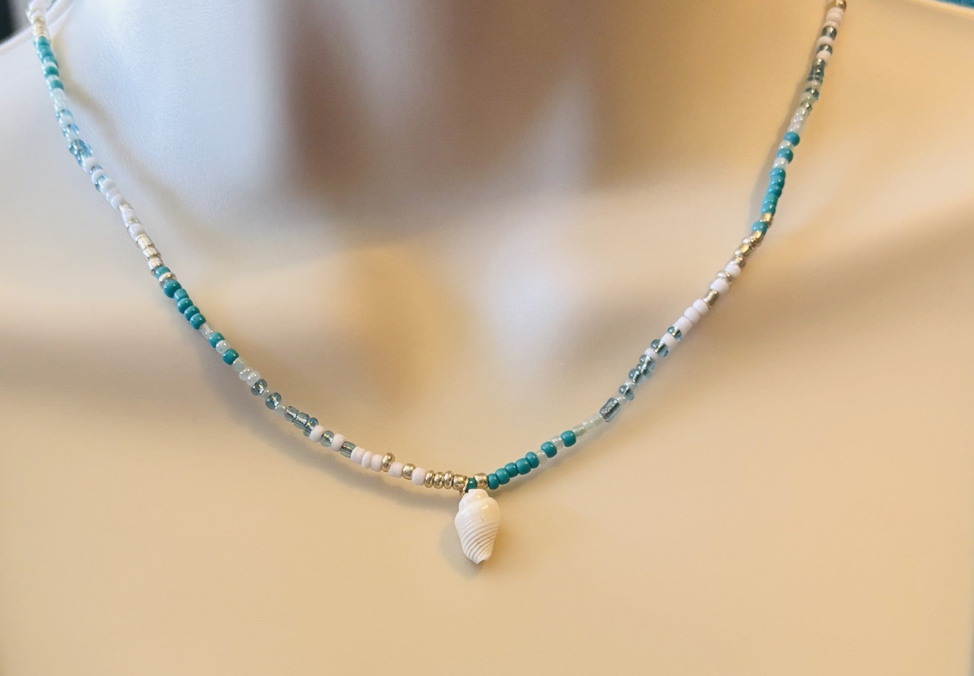 Necklace with shell pendant on a mannequin