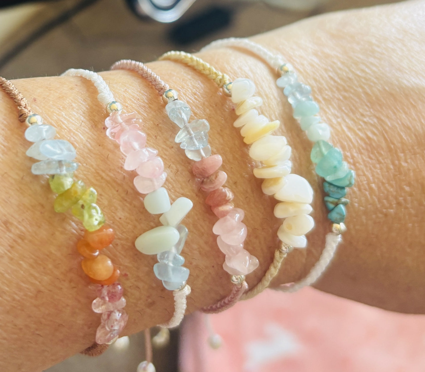 Close-up of a wrist wearing multiple colorful beaded bracelets.